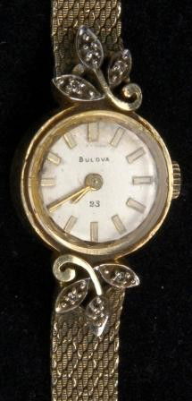 Ladies Bulova 14K Diamond Watch: Ladies Bulova 14K Watch decorated with 3 small diamonds on each end. Gold filled mesh bracelet. 23 jewel movement.