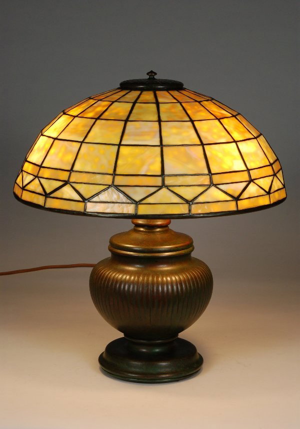 Tiffany Studios Colonial Lamp: Tiffany Studios Colonial Lamp. 16"W Shade of heavily mottled, near Dichroic glass signed 'Tiffany Studios New York 1900'. Bolbous ribbed 'Oil Can' base signed ''Tiffany Studios New York 160'. 18" H.
