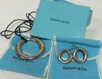 Elsa Peretti Sterling "O" Pend& Earrings By Tiff: Elsa Peretti sterling silver "O" pendant and earings, by Tiffany and Co., black silk cord,each stamped "Tiffany and Co. Elsa Peretti 925 Spain", Pendant 2"w x 2"h. Original felt bags and box.