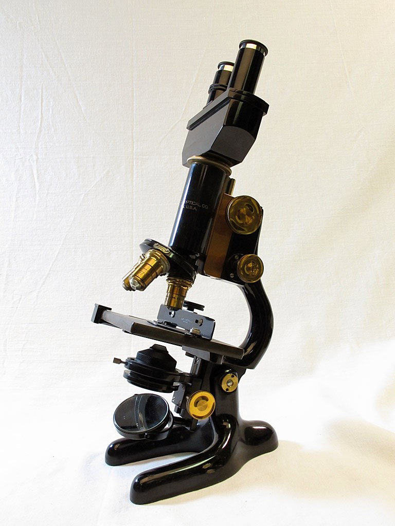 1915 Bausch & Lomb Binocular/Monocular Microscope: 1915 black and brass Bausch & Lomb Microscope with slides, lenses, case. This microscope includes interchangable viewing lenses that allow it to be used in either a monocular or binocular form. High e
