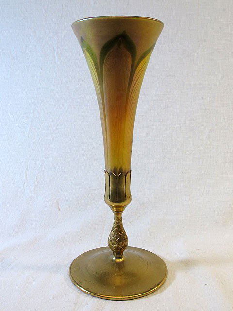 Tiffany Trumpet Vase: Tiffany gold iridescent "feather" design favrile glass trumpet vase, marked "L.C.T.", with dore' bronze base, marked "Tiffany Studios, New York 1043". Lovely iridescent blush interior. 12 1/4" tall.