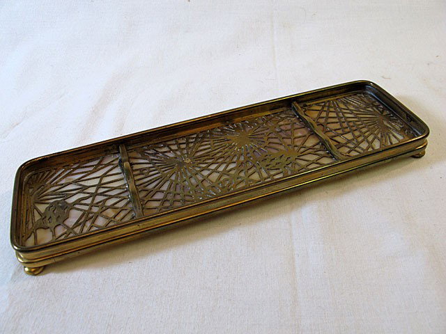 Signed Tiffany Pine Needle Pen Tray: Tiffany pine needle four-footed bronze and glass pen tray with dore finish. Signed Tiffany Studios New York 1004. 5 5/8" x 2 3/4".