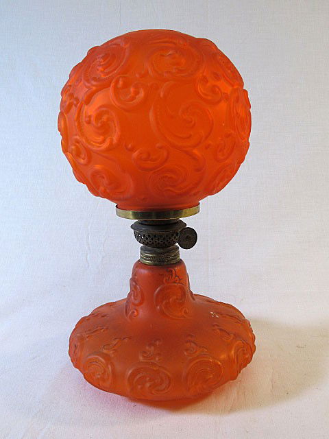 Tangerine Gone With The Wind Parlor Lamp: Rare color and size tangerine Gone With the Wind lamp. Base and globe in tangerine satin glass with foliate swirls. 12", c. late 19th century.