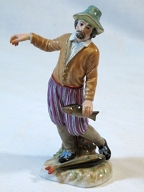 19th Century Meissen Man with Fish: 5 3/4" Man in odd posture with fish. Blue crossed swords mark, incised model numbers.
