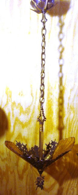 Art Deco Light Fixture: Pierced metal Art Deco hanging fixture was recently removed from original home, retains 90%+ of original finish, complete with original amber glass textured shades, bottom tassle and original dome sha