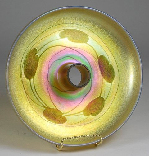 Tiffany Studios Favrile Flower Center Bowl: Early 20th century Tiffany Studios favrile flower center bowl. Rimmed favrile glass bowl with Art Nouveau lilly leaf vine pattern on gold stretched ground with central cylander for flower frog insert