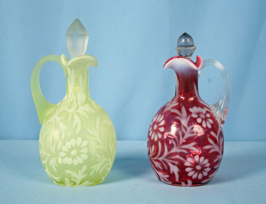 2 Fenton Spanish Lace Cruets Vaseline & Cranberry: Two Fenton Spanish Lace Vinegar Cruets Satin Opalescent Vaseline & Cranberry Opalescent. Approx. 7" and 7.5" high.