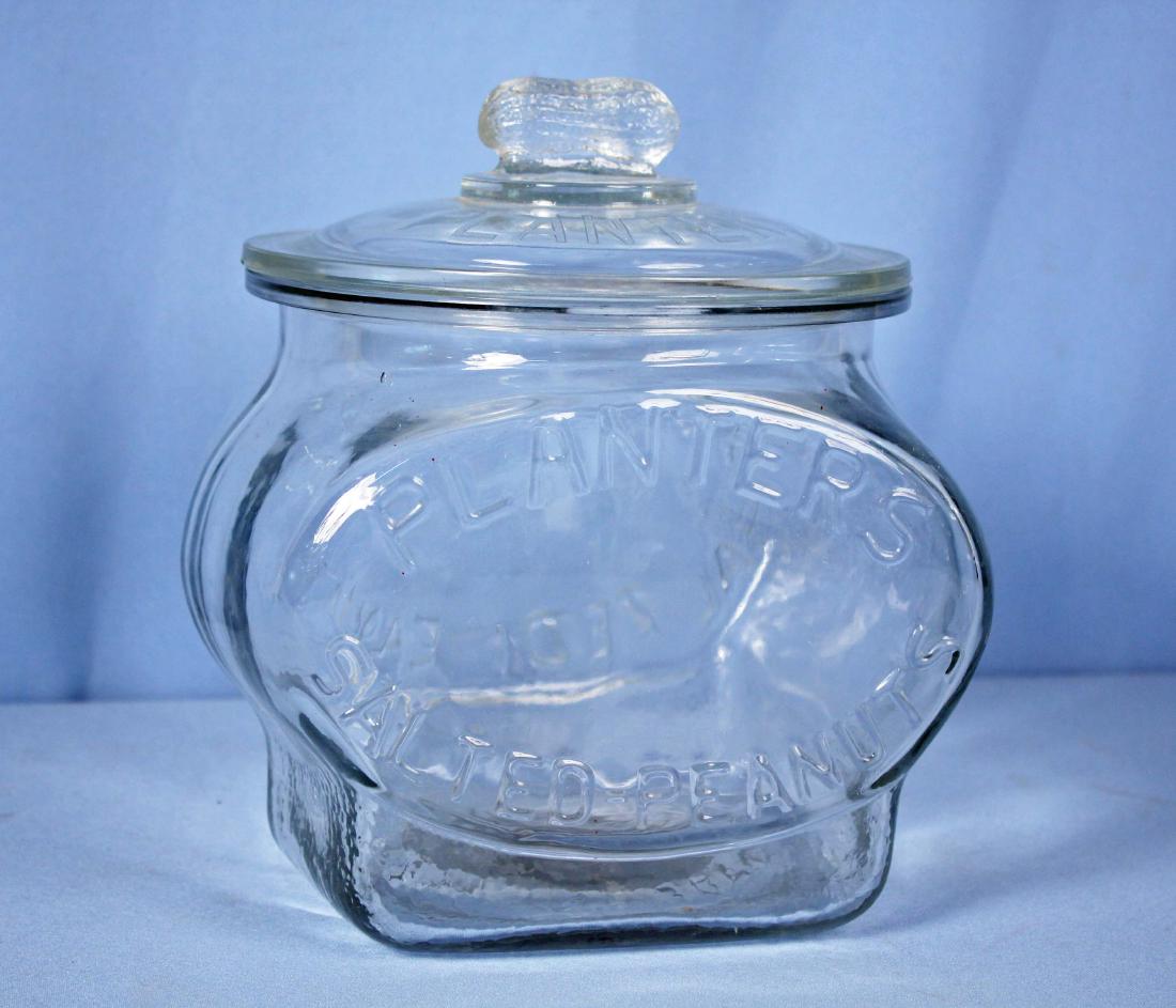 Planters Peanut Glass Display Jar w/ Peanut Finial: Planters Peanut Glass Display Jar with Peanut Finial and Embossed Lettering. 7" X 8" X 9" High.