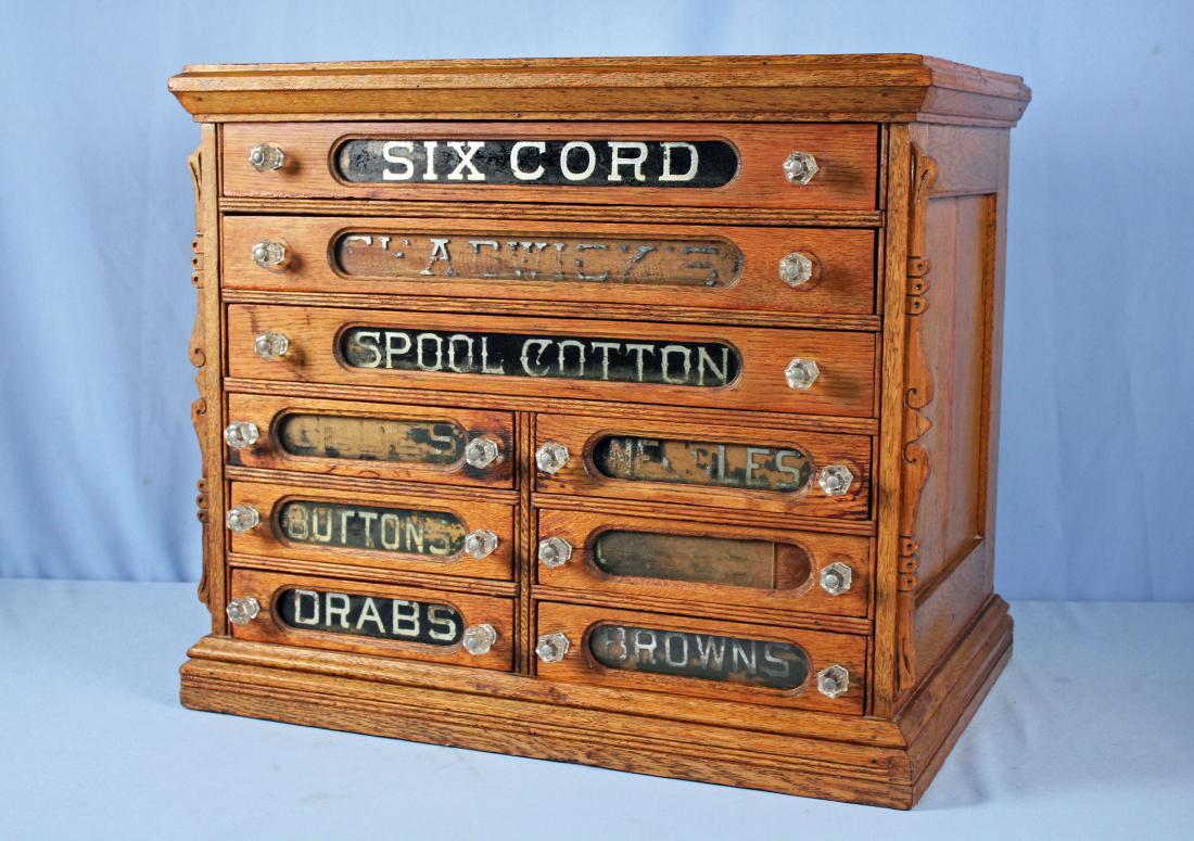 Six Cord Spool Cabinet with 9 Drawers: Six Cord Spool Cabinet with 9 Drawers. Cabinet comes with what appears to be an original blank wood insert for one of the smaller drawers. Measures approx. 22" High X 25.5" Wide X 17.5" Deep. Cabinet 