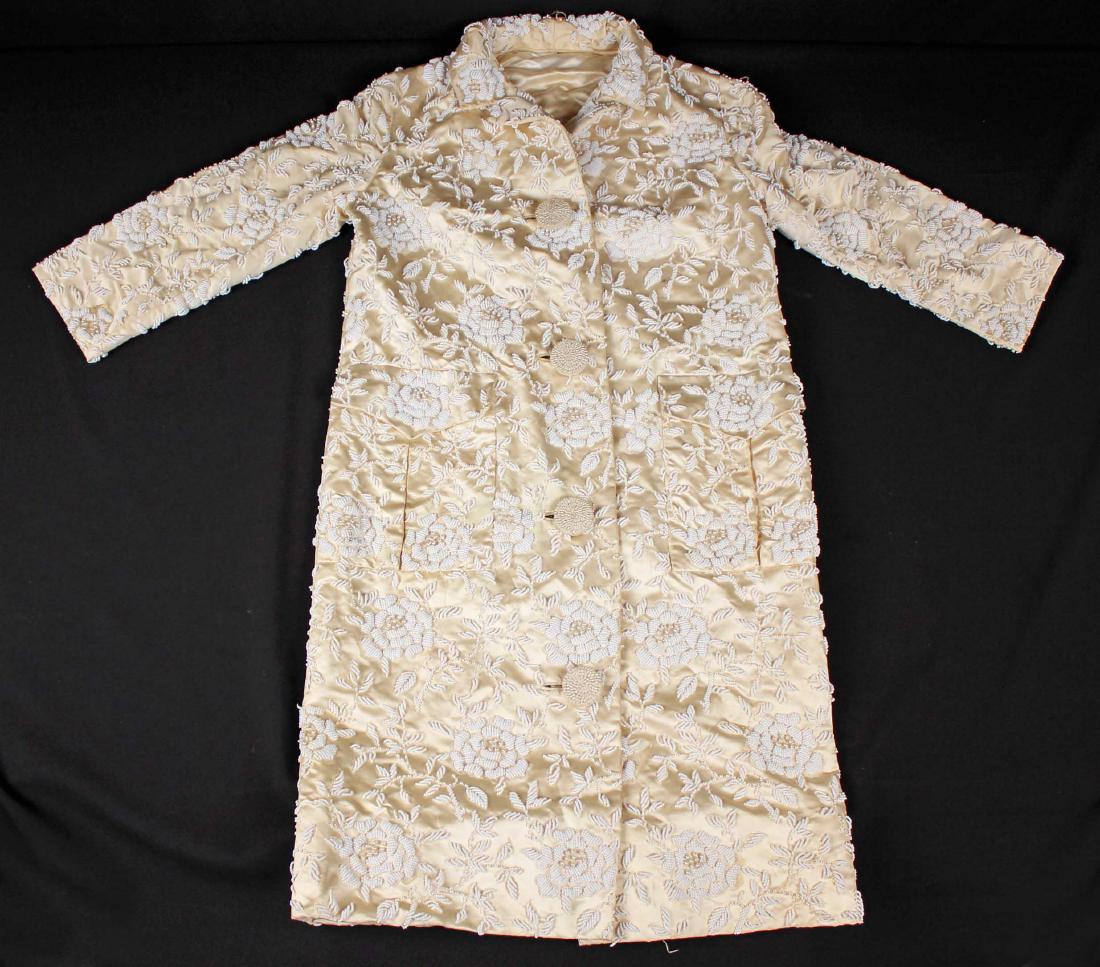 Satin or Silk Ladies Champagne Beaded Coat: Satin or Silk Ladies Champagne Beaded Coat. The coat size is small? . Condition - Lining needs some one minor repair. Coat has some beading loss and small stains.