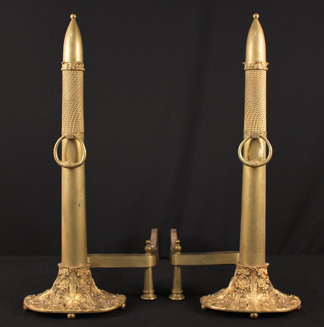 A Pair of Moorish Style Andirons: A Pair of Moorish Style Andirons with Gold Gilt Acanthus Base Decoration. Andirons measure 27 3/4" high X 13" wide to brass support post turn X 24" deep. Base of column is 9 7/8" wide.