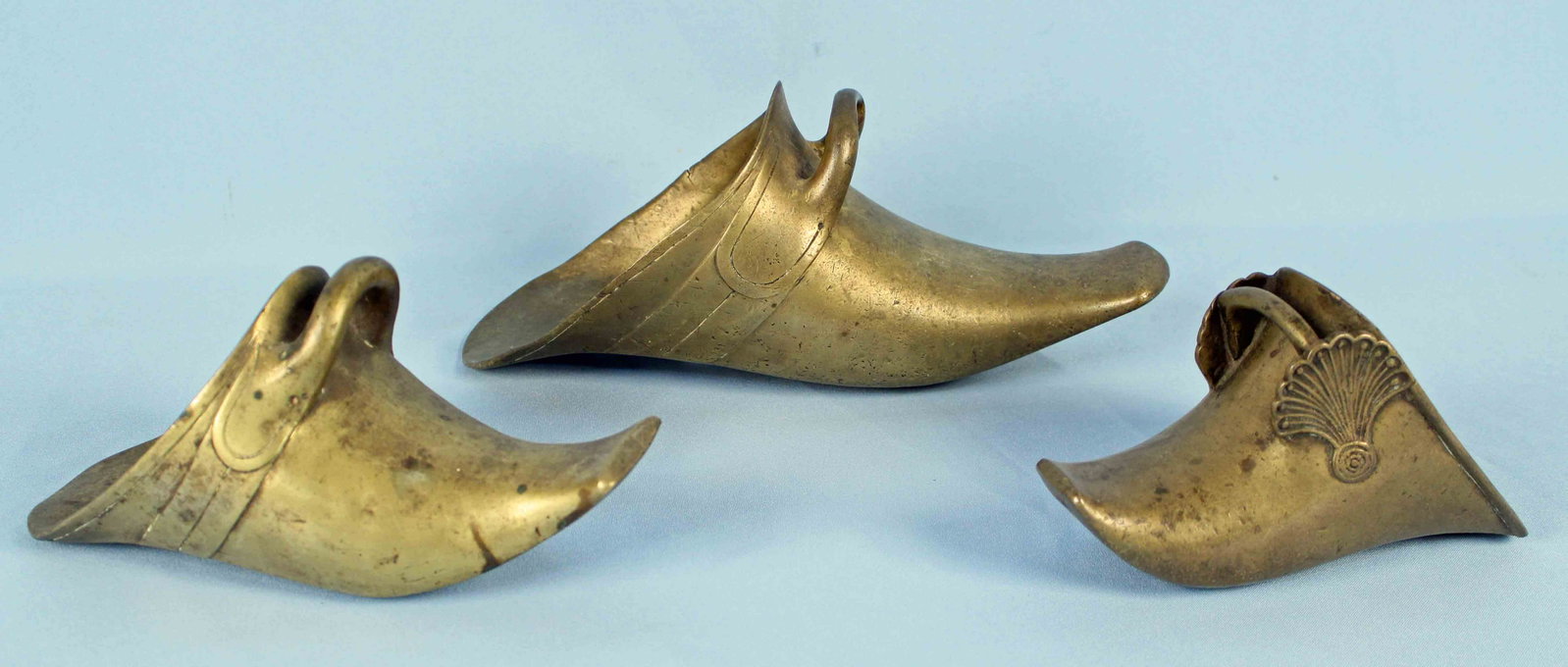 3 Spanish Colonial Conquistador Brass Stirrups: Three Antique Spanish Colonial Conquistador Brass Stirrups. Most likely 16th to 17th century. (1) Measures 12" long x 4 1/2" wide x 5 1/4 high. (1) Measures 9 1/2" long x 3 3/4" wide x 4 1/2" high. (1