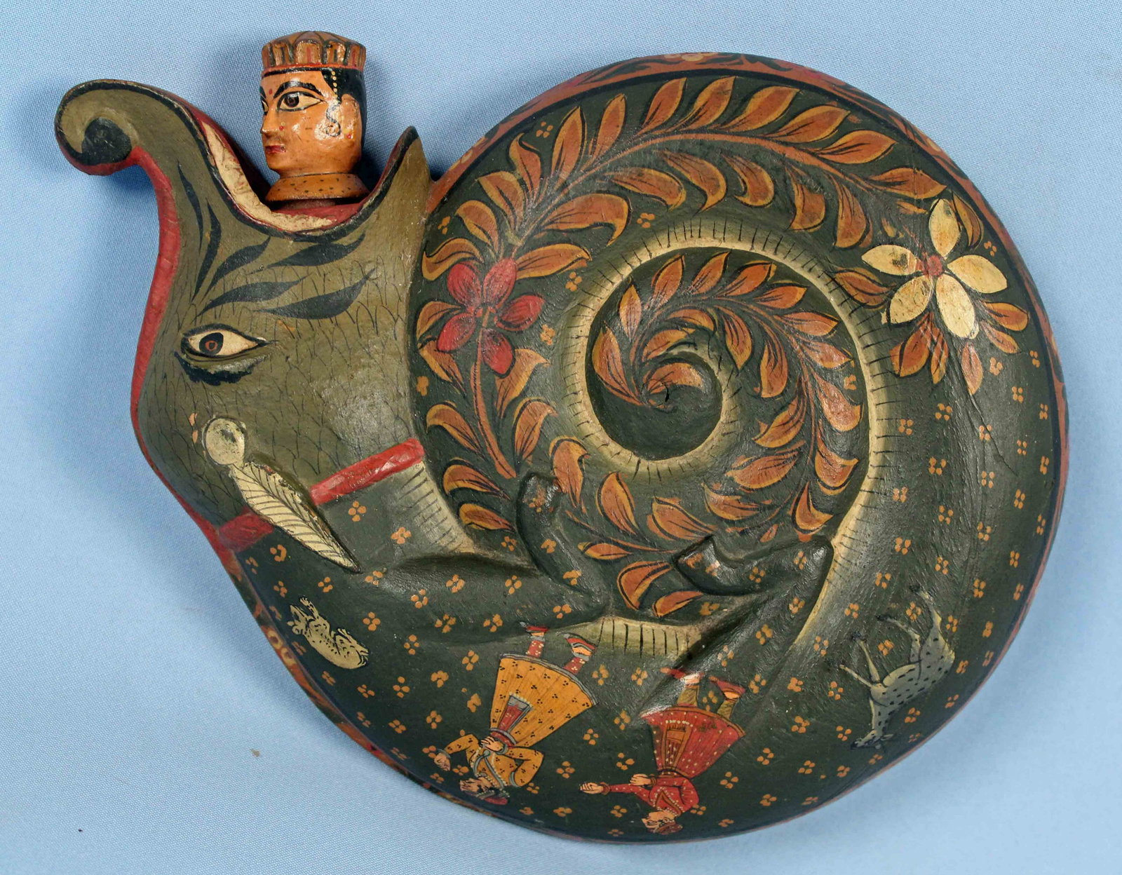 19th C. Indo Persian Carved Makara Powder Flask: 19th C. Indo Persian Carved Makara Powder Flask. Beautiful polychromed and hand carved wooden flask in the form of a curled Makara decorated with figures, animals, archer figure, flowers and leaves, a
