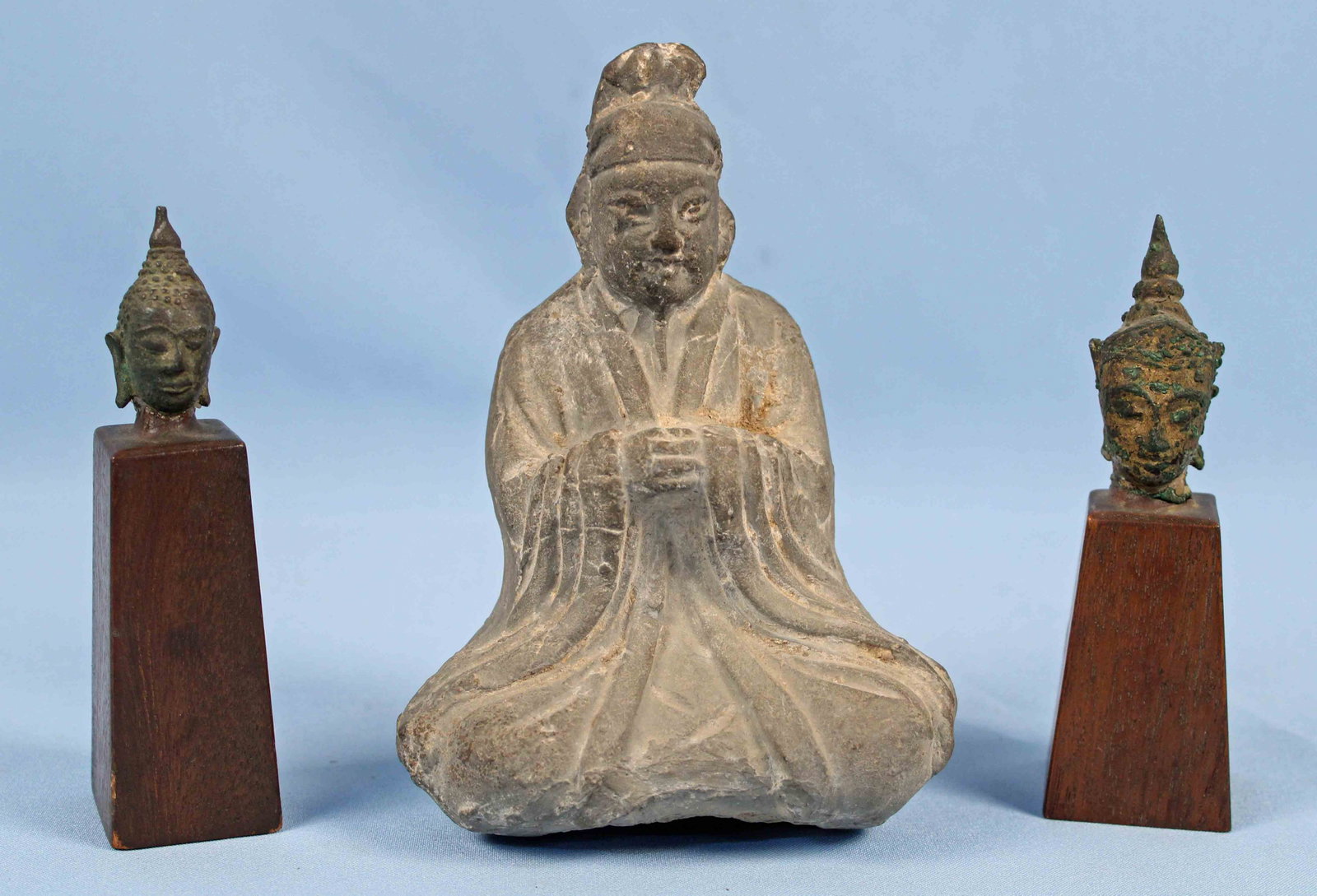 Two Bronze Bust of Buddhist Gods & Seated Buddha: Two Ancient Bronze Bust of Buddhist Gods and Seated Buddha. (1) Seated pottery Buddha 7" High. (2) Bronze bust of Hindu Gods on wooden pedestals approx 5.5" High, bust measure 2" and 2.75" High. Condi