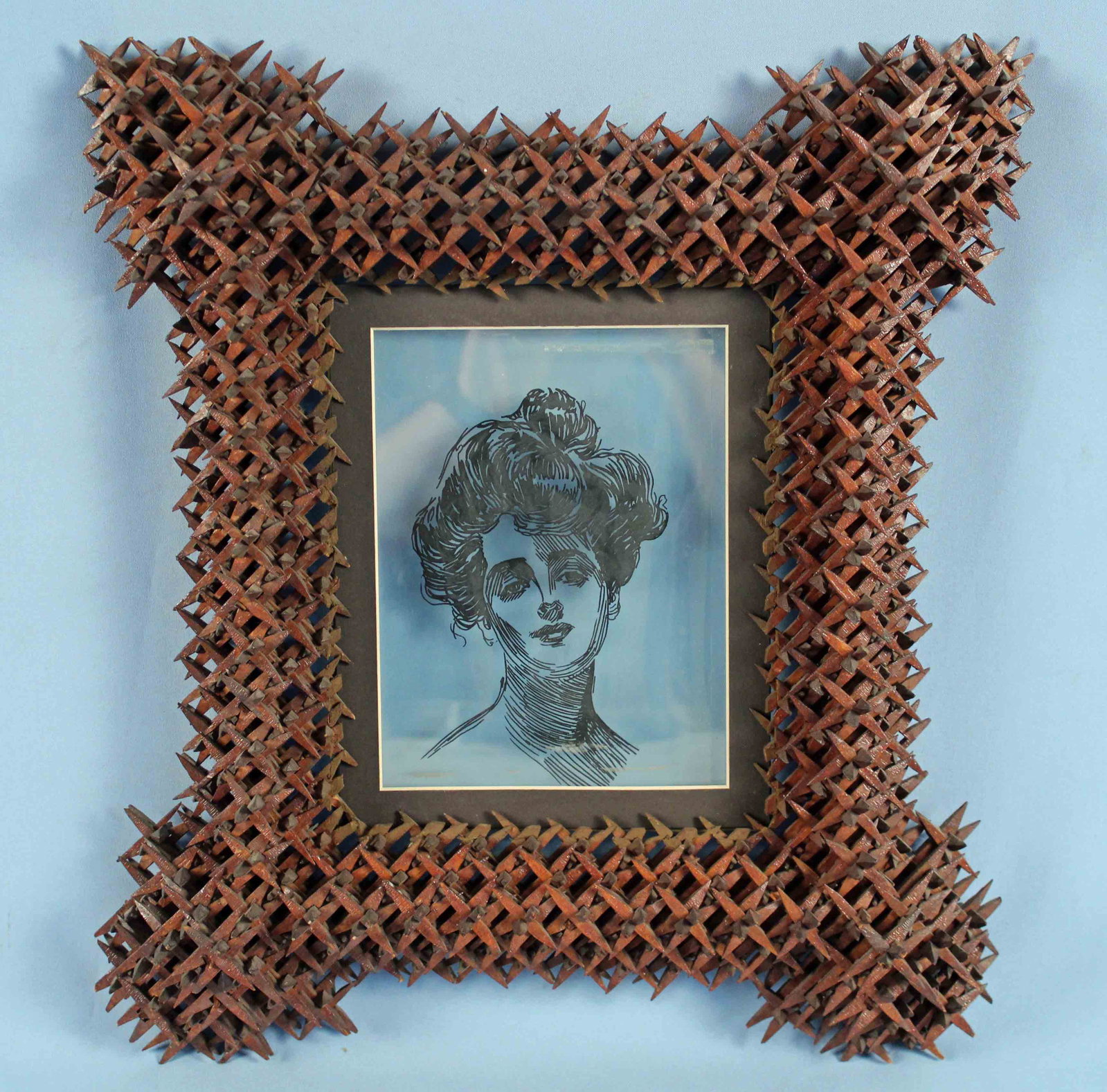 Tramp Art "Crown of Thorns" Walnut Frame C. 1900: Tramp Art "Crown of Thorns" Walnut Frame Circa 1900. Frame has modern screen print of Gibson Girl on glass. Frame measures Approx. 7" X 9 3/4" and overall 16 1/2" X 18 1/4". Condition - Frame is in go