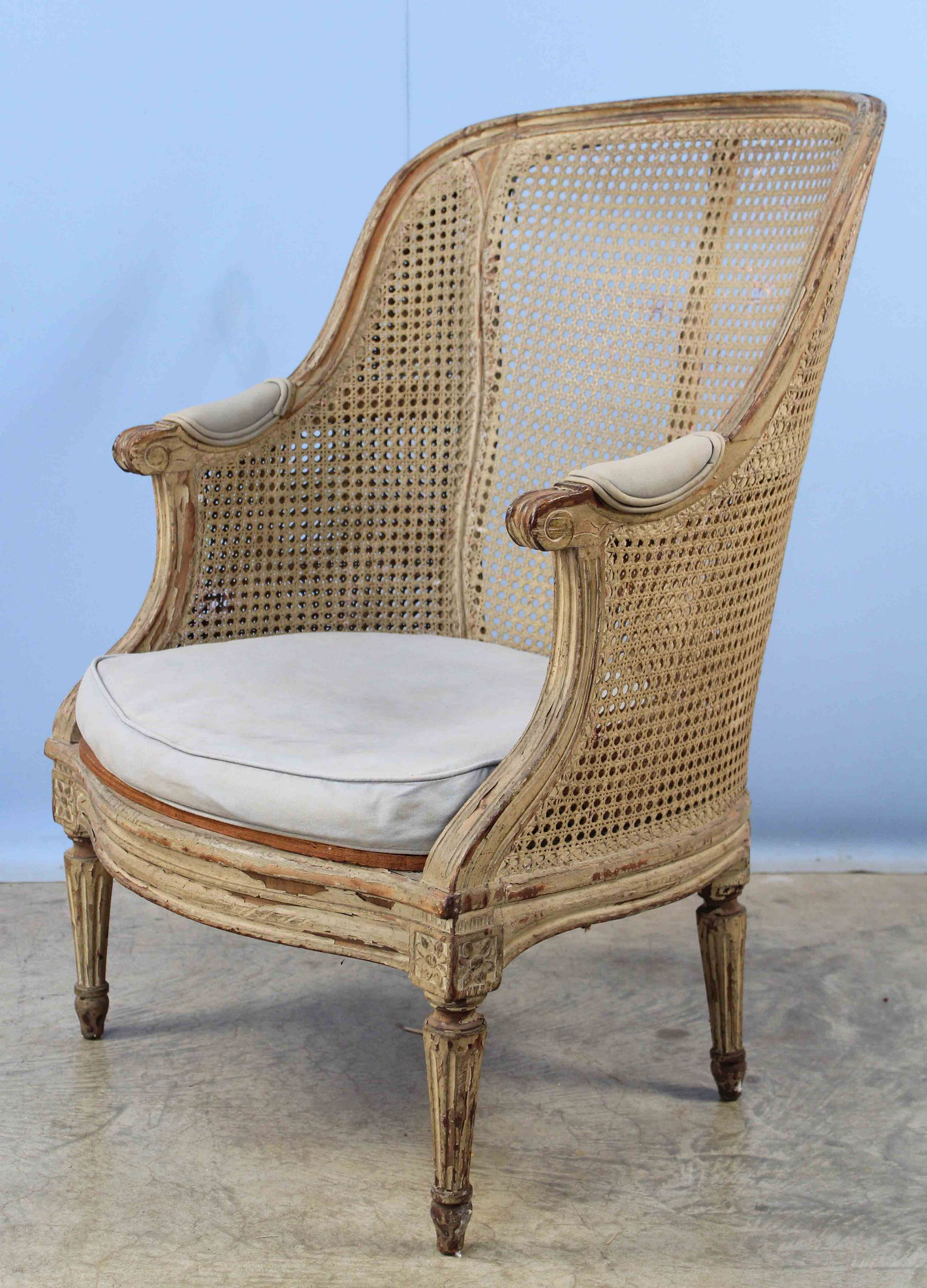 French Louis XVI Style Armchair with Cane: French Louis XVI Style Armchair with Cane. The chair is late 19th C. or Early 20th C. The sides of chair are double cane and back is single cane. Chair measures 37 1/2" H. X 26 3/4" W. X 21" D. Condit