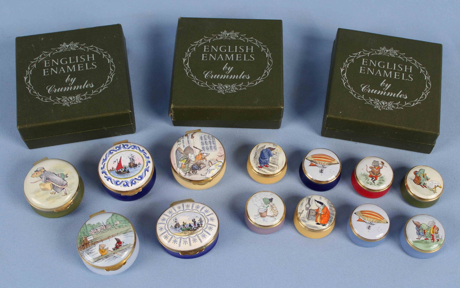 12 Crummles Enamel Boxes 1.5" & 1.25" Dia.: 12 Crummles Enamel Boxes 1.5" & 1.25" Dia. (5) 1 1/2" enamel boxes and (7) 1 1/4" Enamel boxes. Condition - Good condition