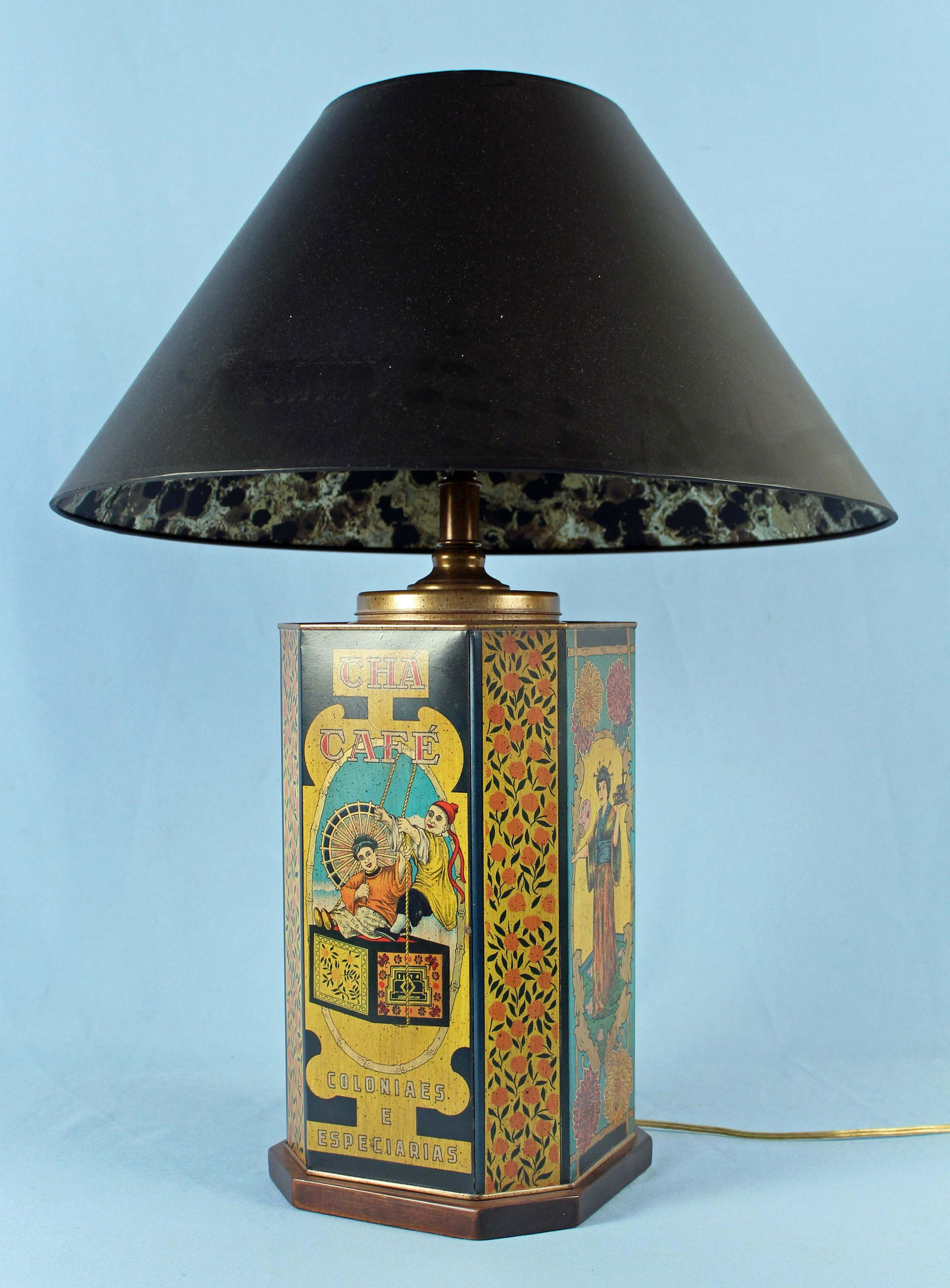 Frederick Cooper " Cha Cafe" Tea Tin Lamp: Frederick Cooper " Cha Cafe" Tea Tin Lamp, Mounted on A Wood Base. Lamp measures 28" H. X 9" at base with a 21" Dia. shade. Condition - Good condition.