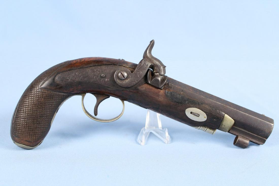 English 19th C. Percussion Travelling Pistol: English 19th C. Percussion Travelling Pistol with 4 1/2" BBL. The gun is approx 45 Cal. Checkered grip and nickel silver engraved fittings including trigger guard. Pistol has cap holder in butt of gri