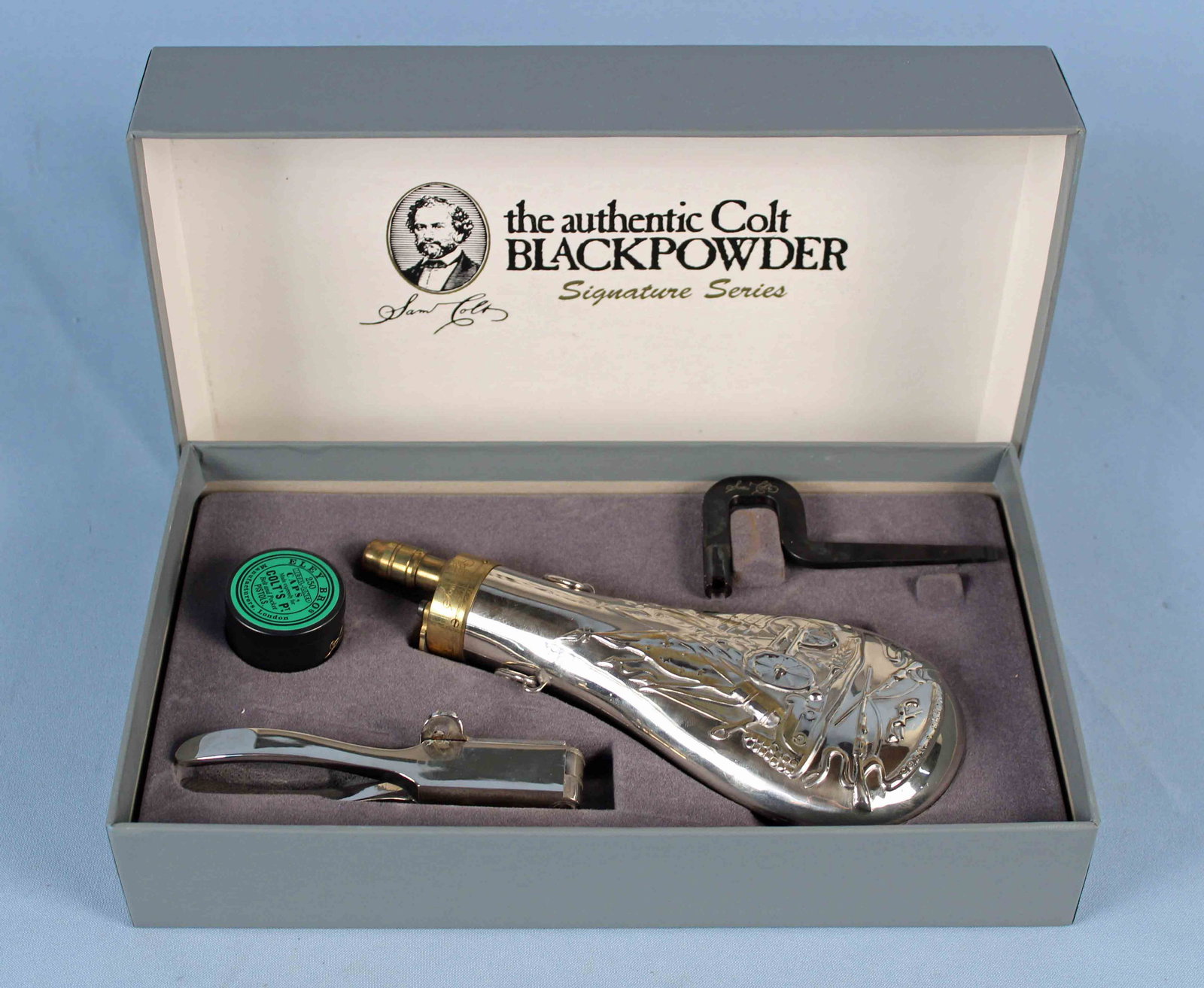 Colt Black Powder Loading Kit Signature Series: Colt Black Powder Loading Kit Signature Series. Kit comes with four pieces, all engraved with Sam Colt's signature: bullet mould, powder, flask, cap tin, and wrench. Condition- Box has some wear. Piec