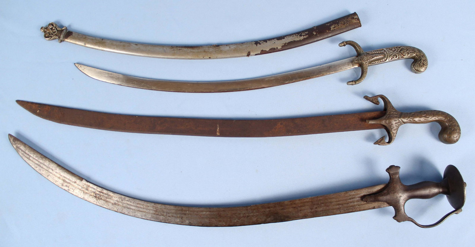 3 Persian Shamshir Swords: 3 Persian Shamshir Swords. (1) Sword with scabbard and decorated hilt measures approx. 26 3/4" long. (1) Sword has Islamic text on hilt and measure approx. 29 5/8" long. (1) Sword with guard measures 