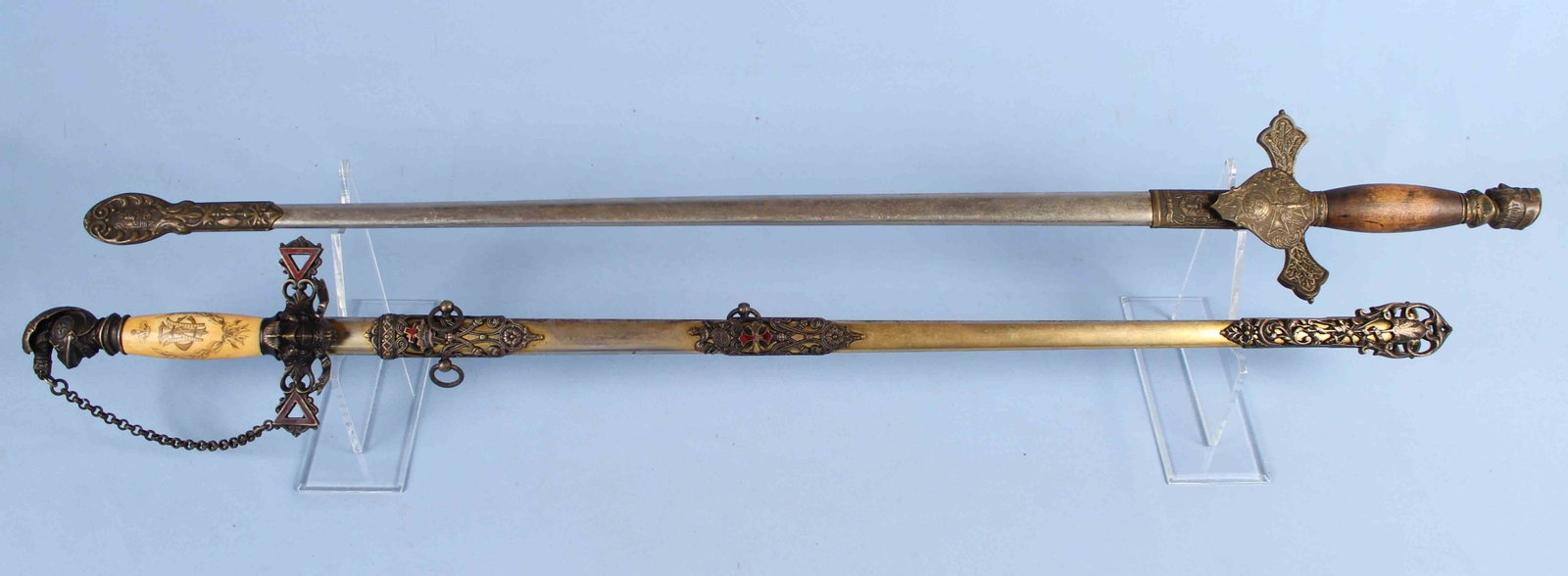 Two Masonic Ceremonial Swords, Templar & Columbus: Two Masonic Ceremonial Swords, Knights Templar and Knights of Columbus. (1) Templar sword has bone handle with inlaid cross. Scabbard and sword are heavily decorated. Sword is marked with the original