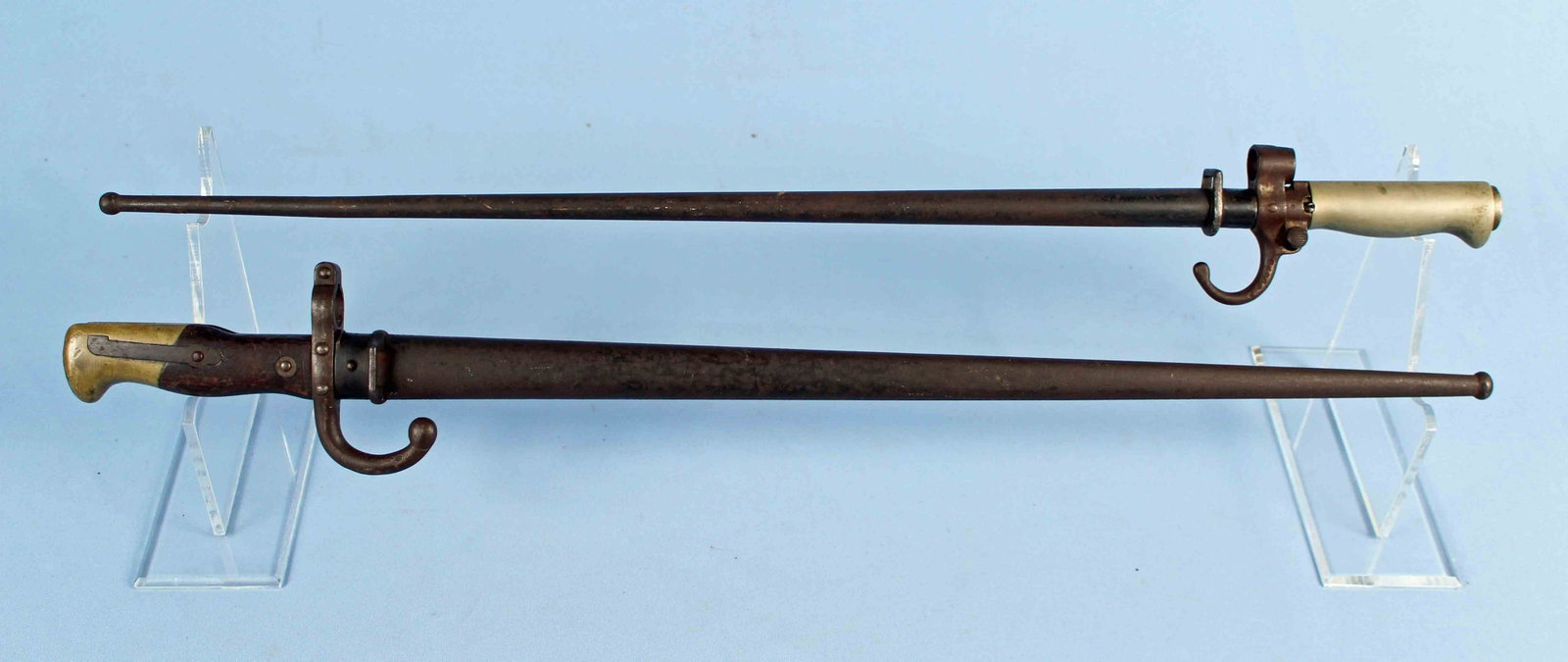 Two Late 1800s French Bayonets: (1) French M1874 Gras T Form Bayonet. Bayonet has inscribed blade, "St. Etienne 1879." Blade measures 20 1/2" long. (1) WWI French Lebel Bayonet (1886-1915). Sword and scabbard have matching S#- 69079