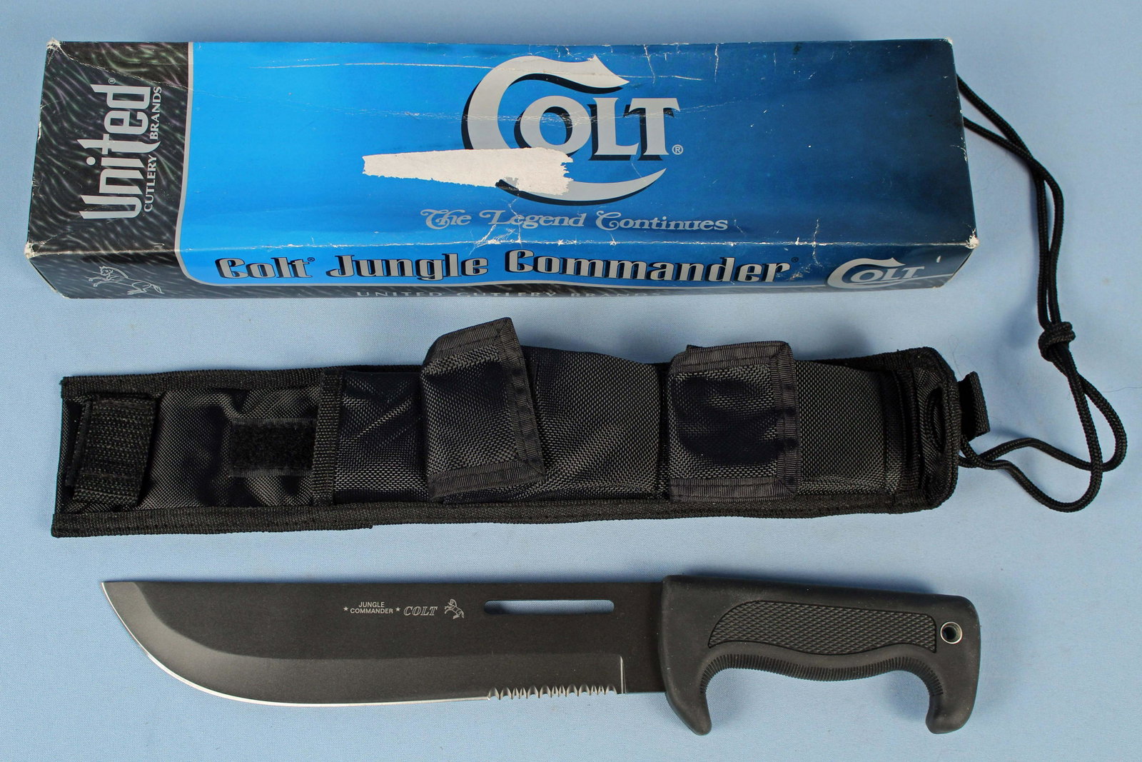 Colt CT45 Jungle Commander Knife w/ Sheath: Colt CT45 Jungle Commander Knife with Sheath. The knife measures 14 1/2" Long and the blade is 2" Wide at the widest point. This knife is in the original box and has never been used. Condition - This 