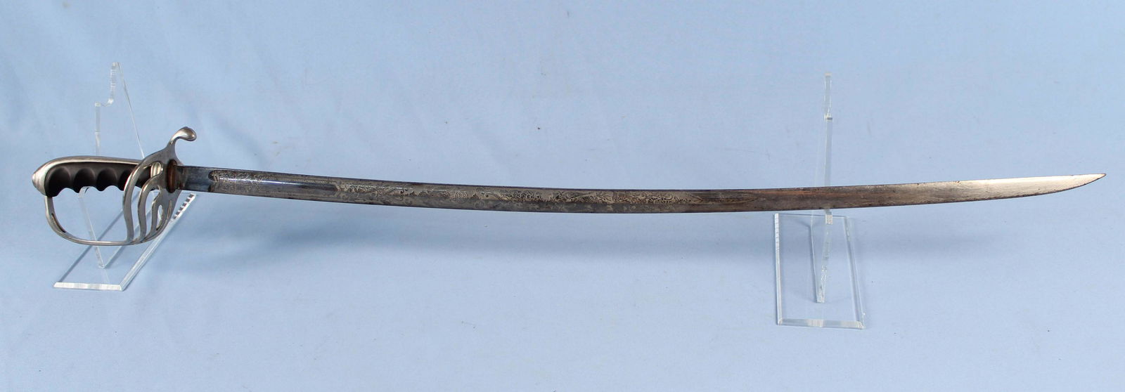 M1902 Officer Dress Sword: Sword is marked in a six pointed star, "H PROVED," with a cross. The blade is marked, "US," and has etched decoration. Blade measures 30 7/8" long. Sword measures 36 5/8" long. Condition- Sword has so