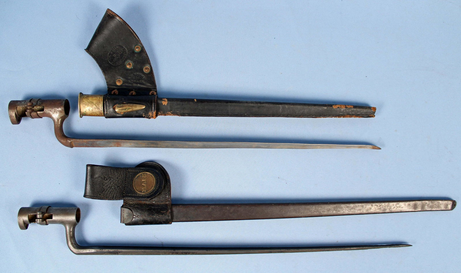 1873 Trapdoor Bayonet & 1858 Musket Bayonet: 1873 Trapdoor Bayonet & 1858 Musket Bayonet. (1) US 1873 45/70 Trapdoor Rifle Bayonet and scabbard with Mass. brass medallion on leather frog. Leather is stamped G227. Blade measures 18" long. Overall