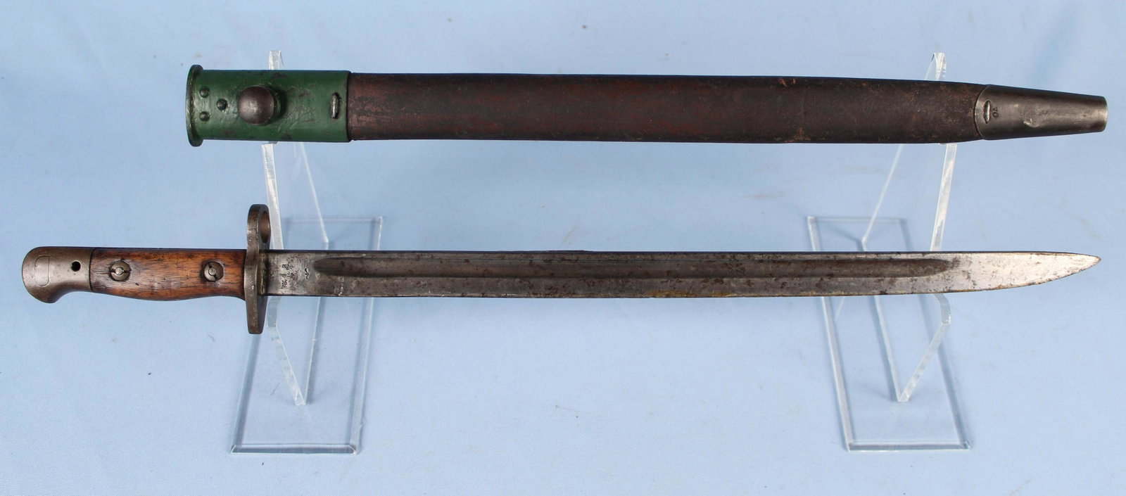 1907 Enfield Wilkinson Bayonet with Scabbard: 1907 Enfield Wilkinson Bayonet with Scabbard. The blade measures 16 7/8" Long. Condition - Overall good condition with some wear.