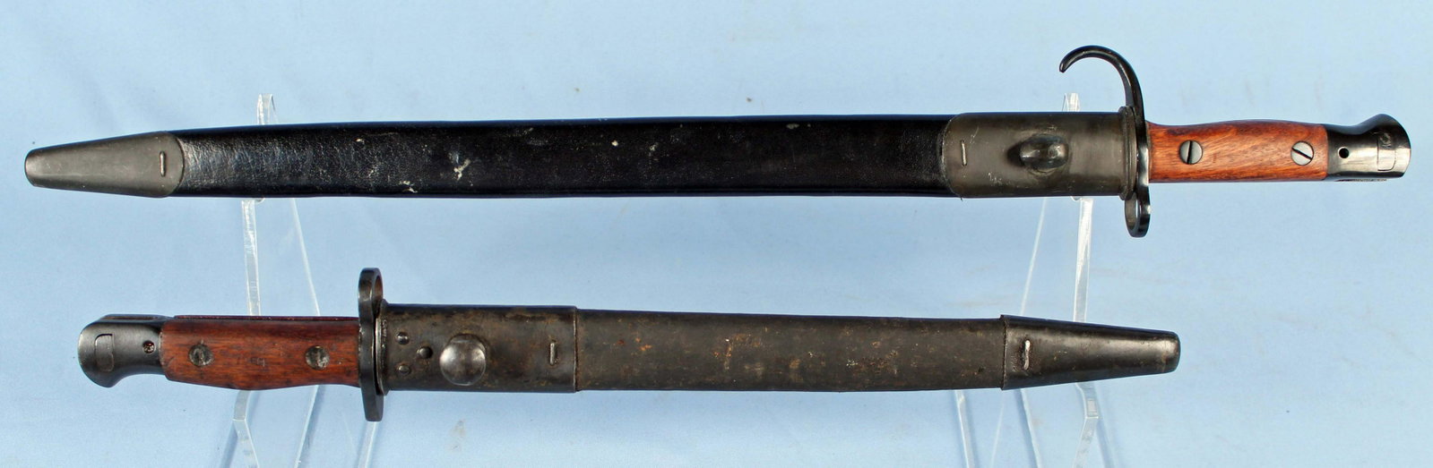Two WWI WWII Era British Bayonets: Two WWI WWII Era British Bayonets. (1) Enfield 1907 G.R Bayonet. Marked, "crown, G.R, 1907, EFD, 11, 11, and inspection stamps. Blade measures 17 1/8" long. (1) 1942 R.F.I Mark II Bayonet with Scabbar