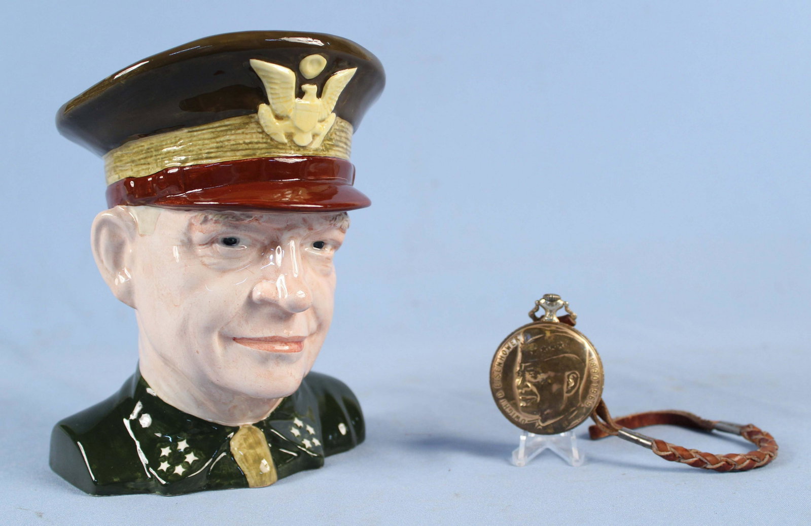 Dwight Eisenhower Toby Mug & Pocket Watch: Dwight Eisenhower Toby Mug & Pocket Watch. (1) Barrington Dwight Eisenhower Toby Mug. Measures 7 1/4" high. (1) Arnex Presidential Dwight D. Eisenhower brass cased pocket watch. Watch his patriotic de