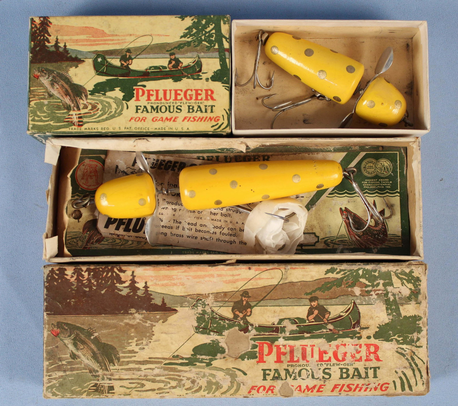 Pflueger No. 3750 3 5/8" & 5 1/4" Fishing Lures: Pflueger No. 3750 3 5/8" & 5 1/4" yellow Gold Fishing Lures with Original Boxes. (1) 5 1/4" globe bait fishing lure large game fish size with original canoe box and manuals. (1) 3 5/8" globe bait fish