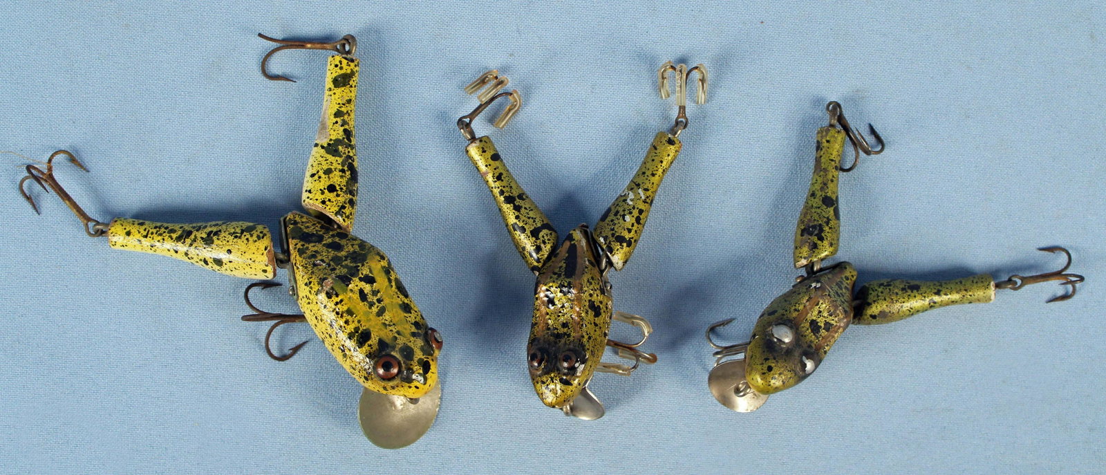 Paw Paw Wotta Frog Fishing Lures: Paw Paw Wotta Frog Fishing Lures. (1) Large frog is marked, "Paw Paw," on silver bill. Body measures approx. 3 1/2" long. (2) Smaller frogs with unmarked silver bills. Bodies measure approx. 2 7/8" lo