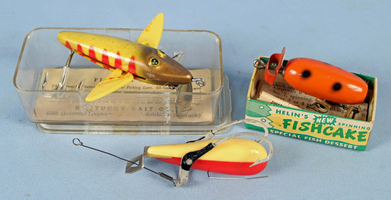 Dozey Boy, Kentucky Flutter Fish, & Fishcake Lure: Dozey Boy, Kentucky Flutter Fish, & Fishcake Lure. (1) 1960 dozey boy mechanical type lure. Manufactured by Accepted Lure Co. and Hasand Inc., Cleveland, Ohio. Two tone, red and white. Body measures a