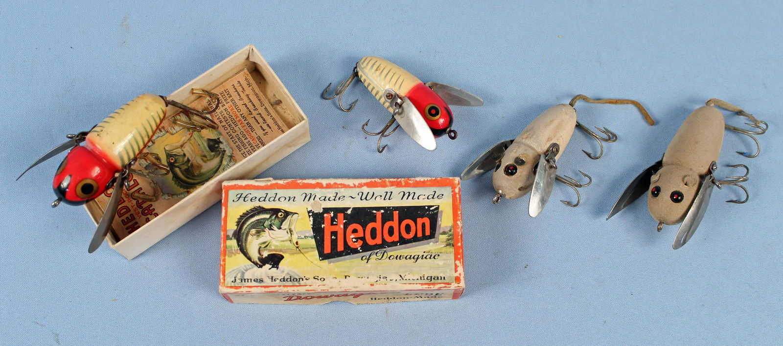 Four Heddon Crazy Crawler Fishing Lures: Four Heddon Crazy Crawler Fishing Lures. (1) Dowagiac #2120 red white and black with the original box and papers, lure body is 2 5/8" Long. (1) Small size red white and black Crazy Crawler, lure body