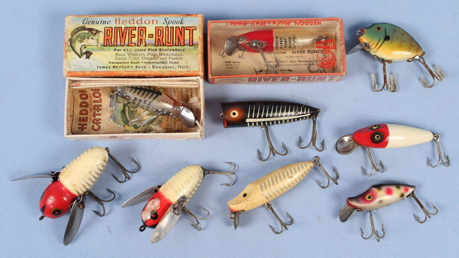 Nine Heddon Fishing Lures: Nine Heddon Fishing Lures. (5) Assorted River Runts. (2) Crazy Crawlers. (1) Chugger Spook. (1) Pumpkinseed. Condition - The small Crazy Crawler has paint damage. The balance of the lures are in overa
