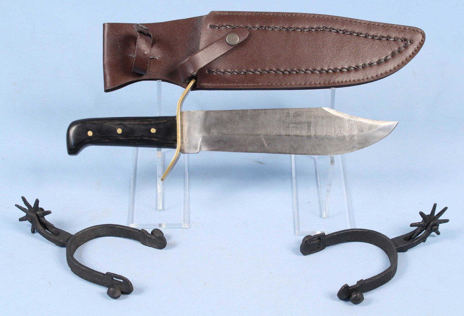 Bowie Style Knife w/ Damascus Blade & Spurs: Bowie Style Knife w/ Damascus Blade and Leather Sheath. Blade measures 9 3/4" long. (2) Cast iron decorator horseshoe cowboy spurs. Condition- Knife is in good condition with some wear. See photos.