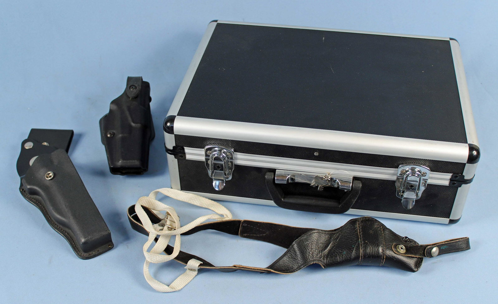 Aluminum Gun Case and Holsters: (1) Aluminum case with adjustable foam 18" X 13" X 6 1/4". (1) Shoulder rig for small caliber pistol. (1) Safariland 6360-83 Glock 17 .22. (1) Reno unknown model holster. Condition - Good overall cond