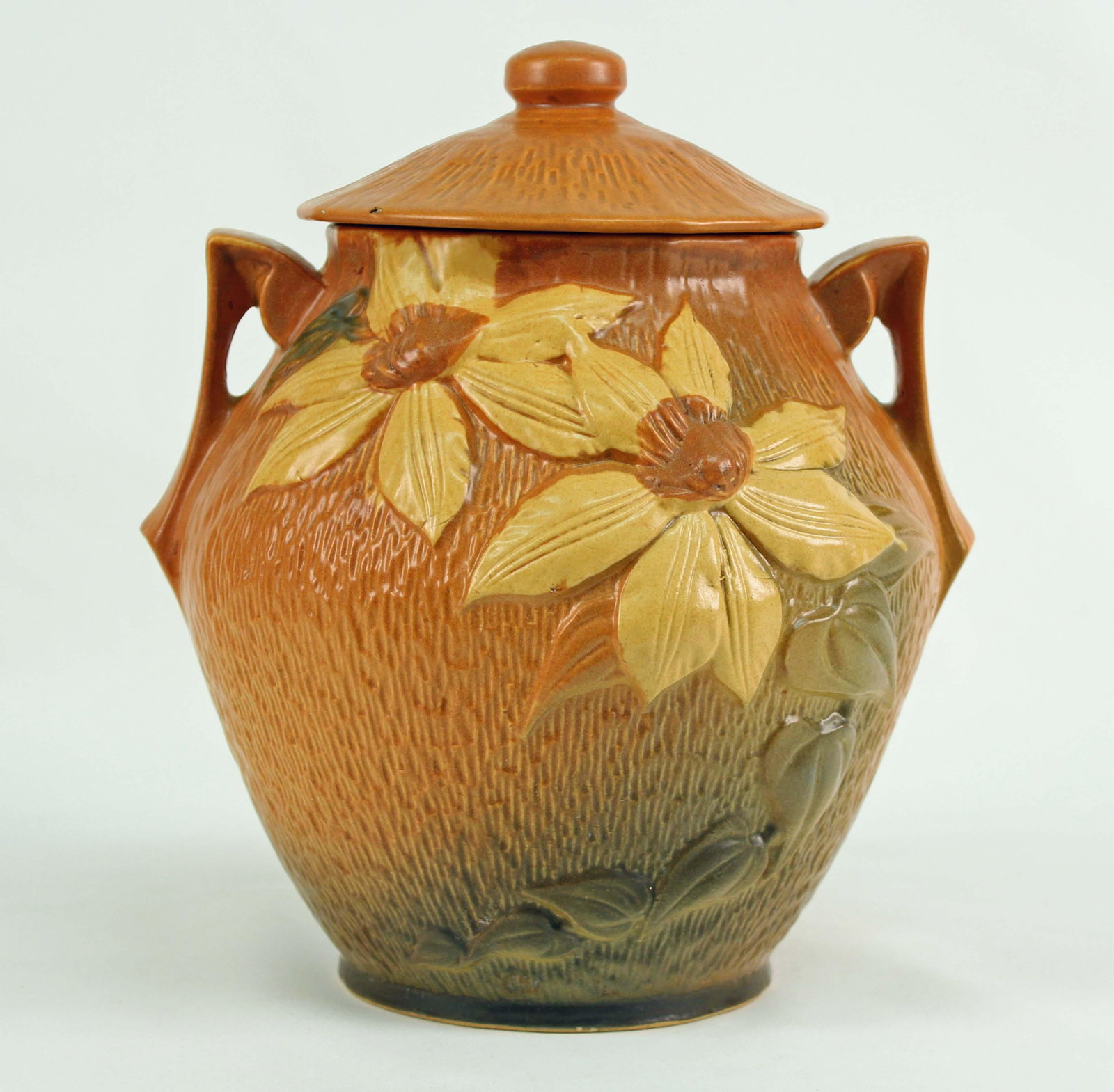 Roseville Pottery Clematis Flower Cookie Jar: Roseville Pottery Clematis Flower Cookie Jar, #3-8". The jar is 10": High X 9" Dia. Condition - Good condition. No chips or cracks on lid or jar. (See Photos)