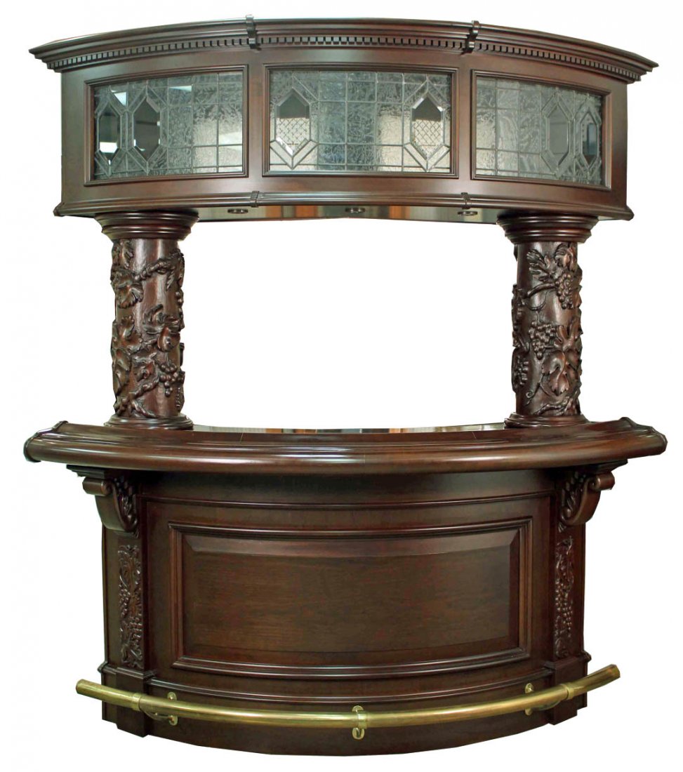 Mahogany Bar w/ Carved Columns & Leaded Glass: Mahogany Home Bar with Grape and Leaf Carved Columns (9 1/2" Dia.) Below Leaded Glass Cabinet Top. The curved bar is lighted with raised beveled panel base and brass foot rail. The serving counter is 