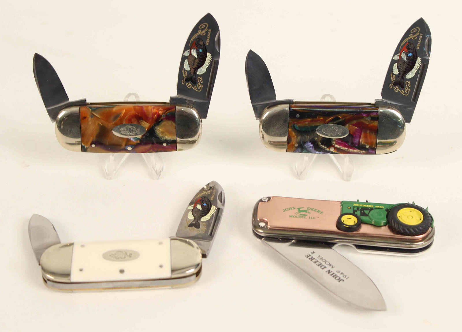 3 Bulldog Brand Celluloid Handle Sunfish Knives: (2) Bulldog Brand Multicolor Celluloid Handle Sunfish Knives. (1) Bulldog Brand knife with white celluloid handles. (1) John Deere 1949 Model R, Franklin Mint commemorative knife. The Bulldog knives w