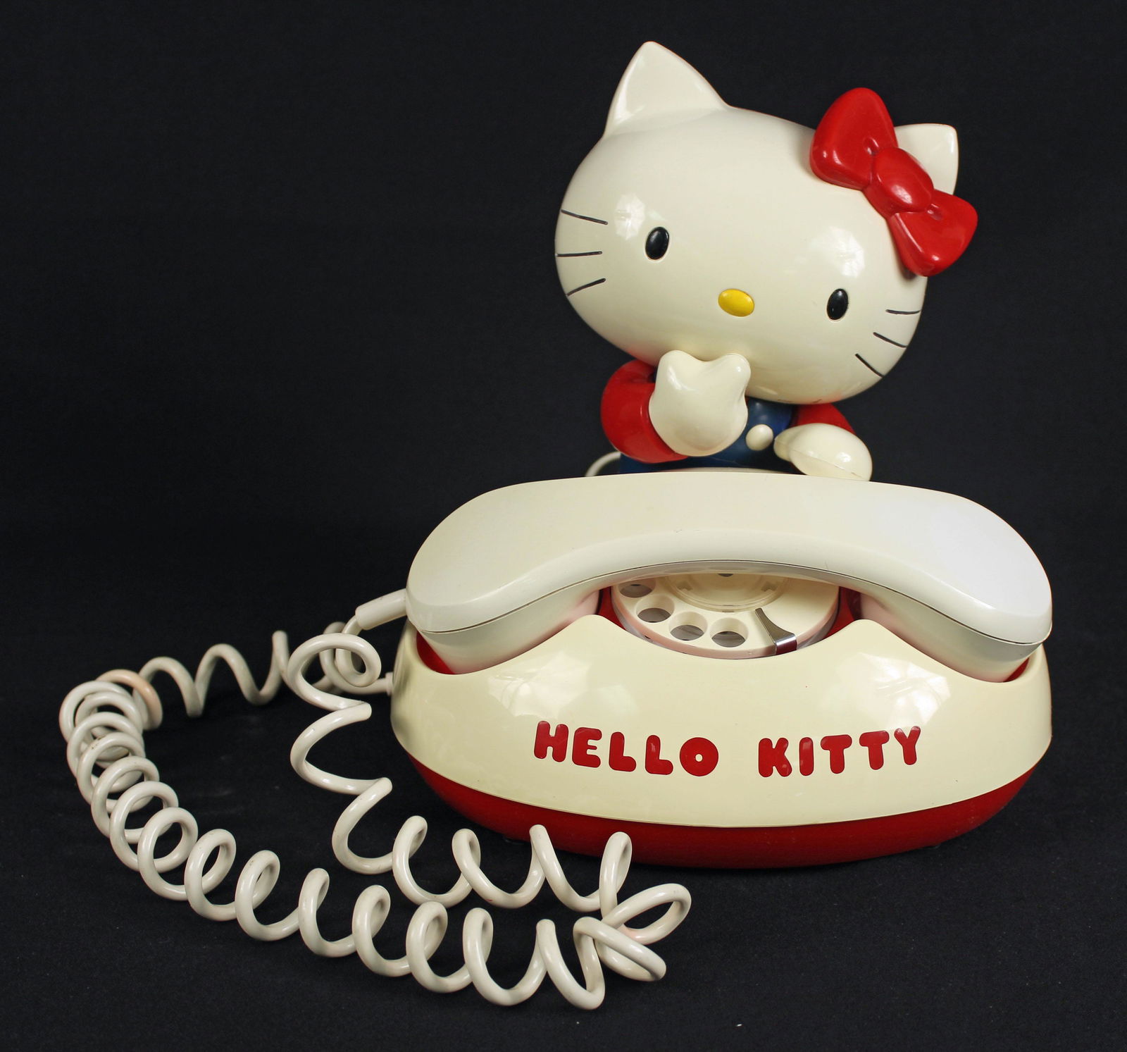 1976 Hello Kitty Rotary Dial Telephone: 1976 Hello Kitty Rotary Dial Telephone. This telephone works very well, receives and sends calls. Measures 10" high x 9" wide x 8" deep. Condition- Telephone has some yellowing to plastic. The receive