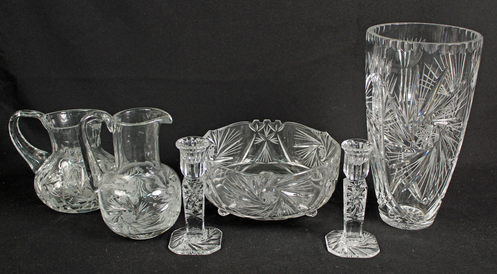 Six Pieces Leaded Crystal Glass, Pitchers Etc.: Six Pieces Etched Leaded Crystal Glass, Pitchers Etc. (2) Juice pitchers 7" and 6" High (1) Footed serving bowl 8 1/2" Dia. (1) Vase 11 1/8" H. (2) Candle holders 6" High. Condition - Good condition.