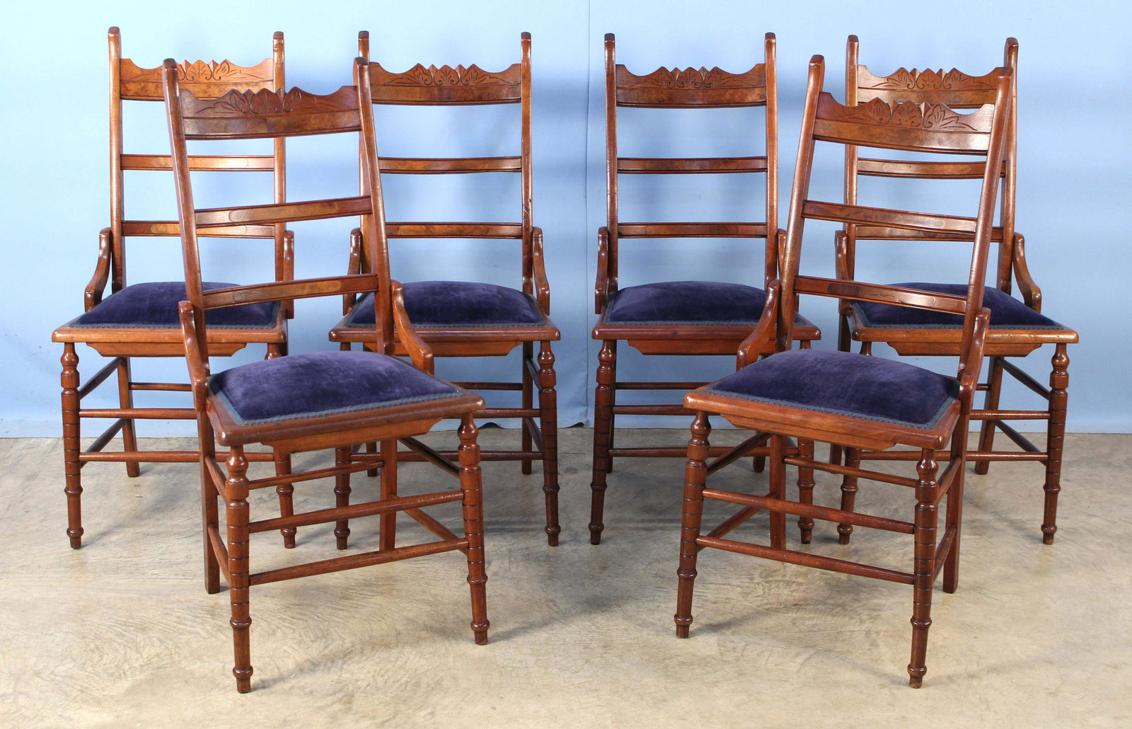 Six Eastlake Walnut Ladderback Chairs: Six Eastlake Walnut Ladderback Chairs with Blue Velvet Seats. Measures 39 1/4" high x 17 3/4" wide x 20" deep. Condition- Chairs are in good condition. See photos.