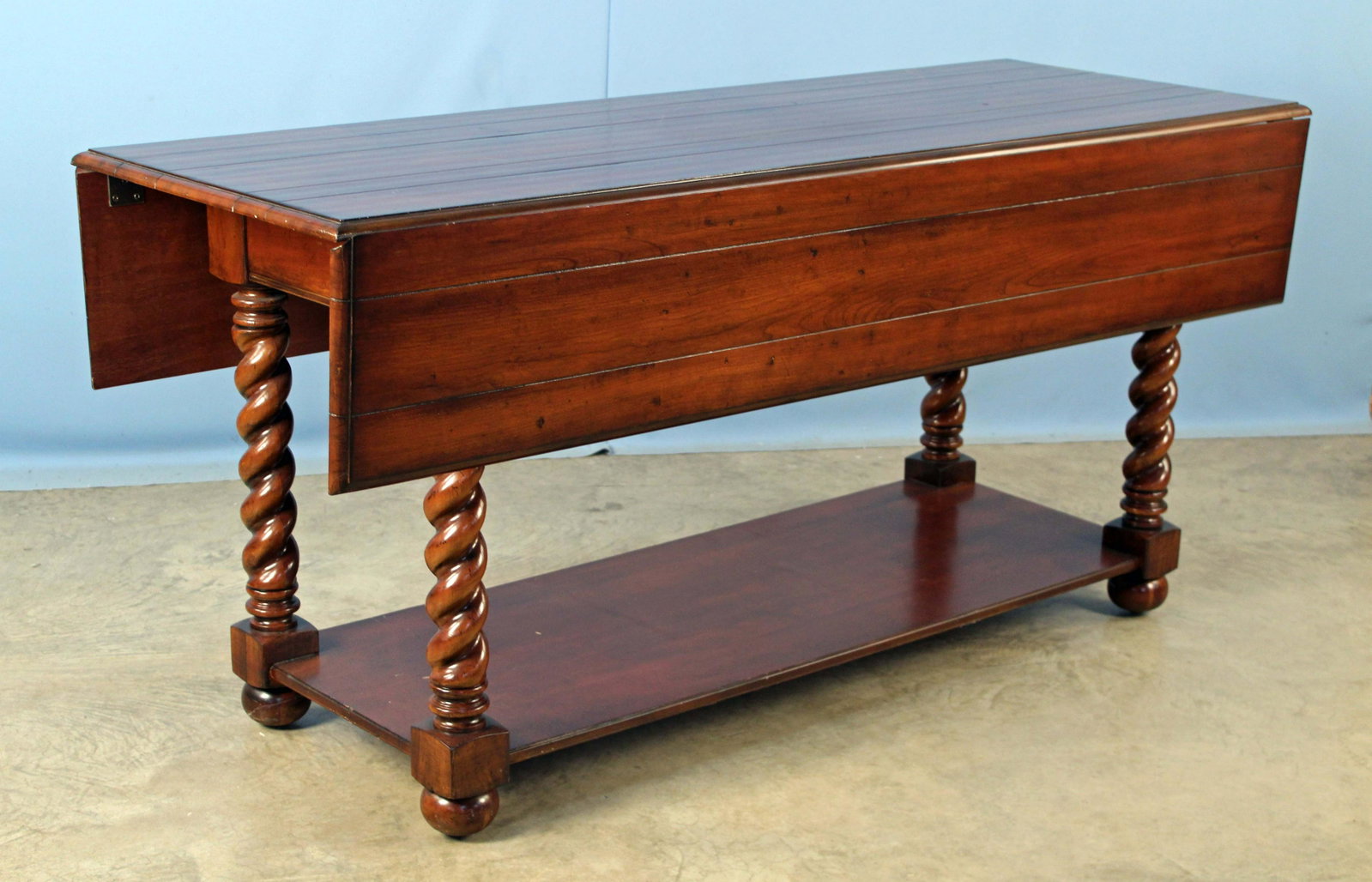 Hooker Beladora Jacobean Twist Console: Hooker Beladora Jacobean Twist Console Table. Console table has a walnut finish and two drop leaves. Measures 31" high x 66" long x 45" wide and weighs 158 lbs. Condition- Console table is in good con