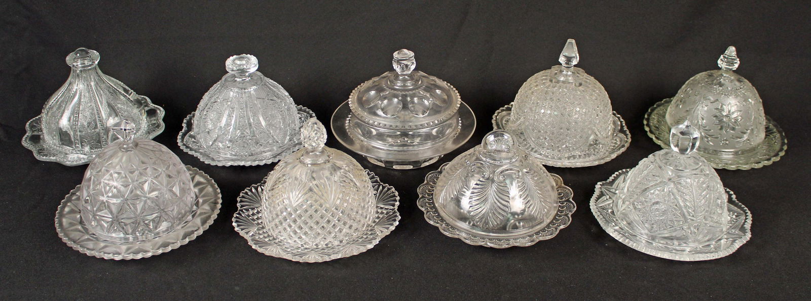 Group Nine Pressed Glass Butter Dishes: Group Nine Pressed Glass Butter Dishes. The butter dish sizes are very similar and include - (1) Russ Vogelsong, Summit Glass, Holly Band clear butter dish, 7 3/8" Dia. X 5 3/4" Dia. (1) Indiana Glass