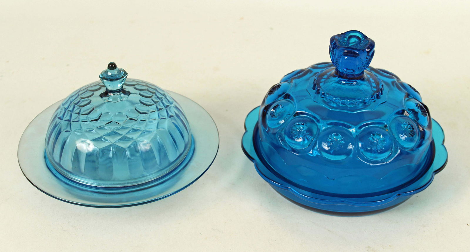 2 Blue Butter Dishes, Aunt Polly and Moon & Stars: Two Blue Butter Dishes, Aunt Polly and Moon & Stars. (1) U.S. Glass "Aunt Polly" Blue Butter Dish, 7" Dia. (1) L.E. Smith "Moon and Stars" blue butter dish 7 1/2" Dia. Condition - Both dishes are in g