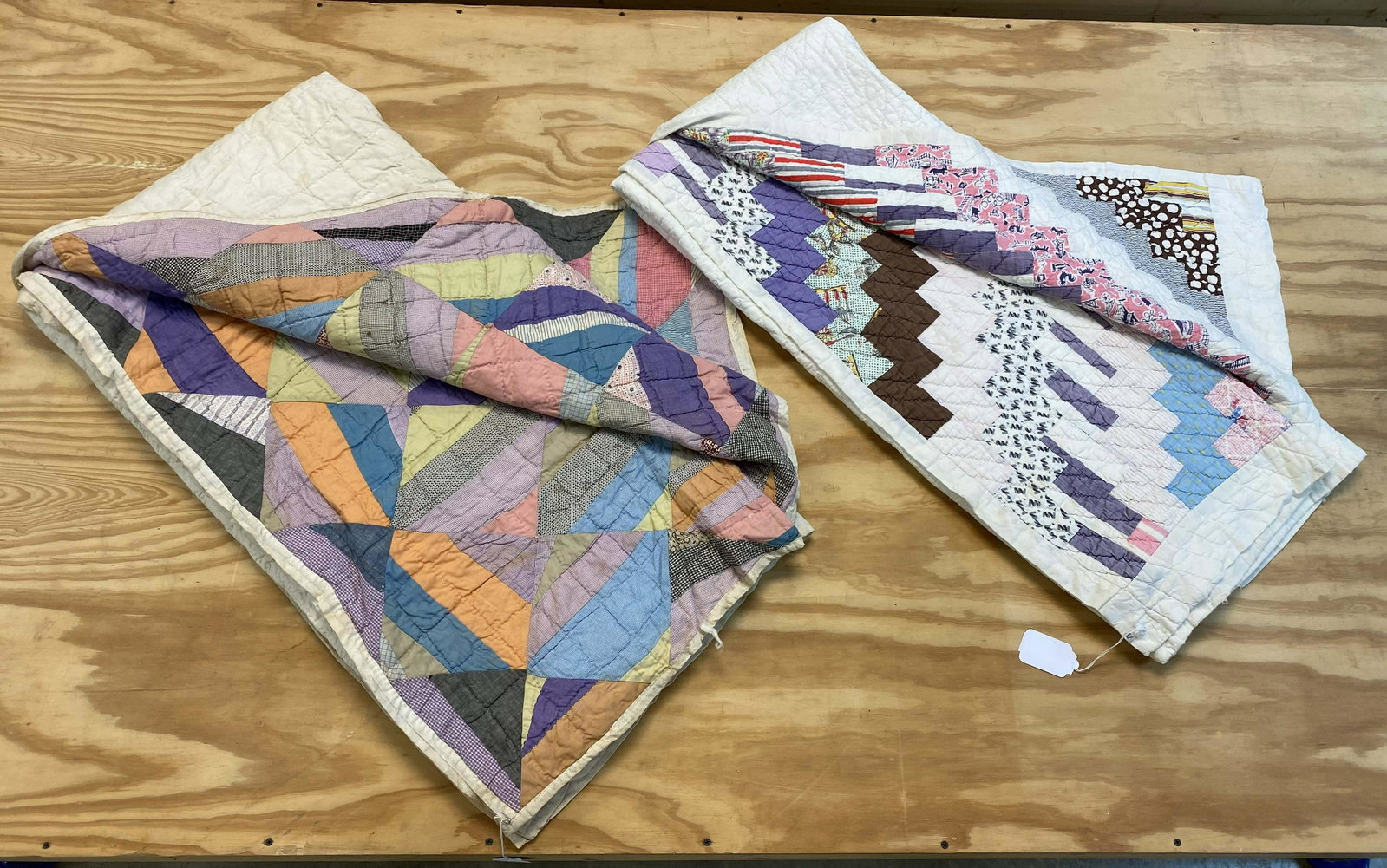Two TN Handmade 20th C. Multi-Colored Quilts: Two TN Handmade 20th C. Multi-Colored Quilts. (1) Largest quilt measures 77 1/2" x 79". (1) Diagonal block quilt measures 64" x 75". Condition- Larger quilt has one small tear and several stains. Smal